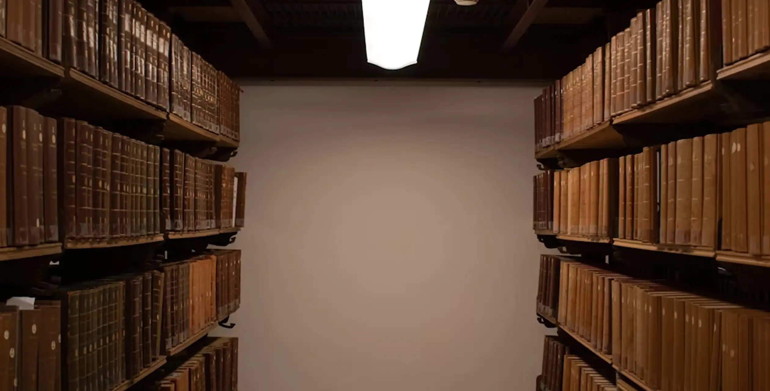 Rows of shelves filled with old books in an archive room